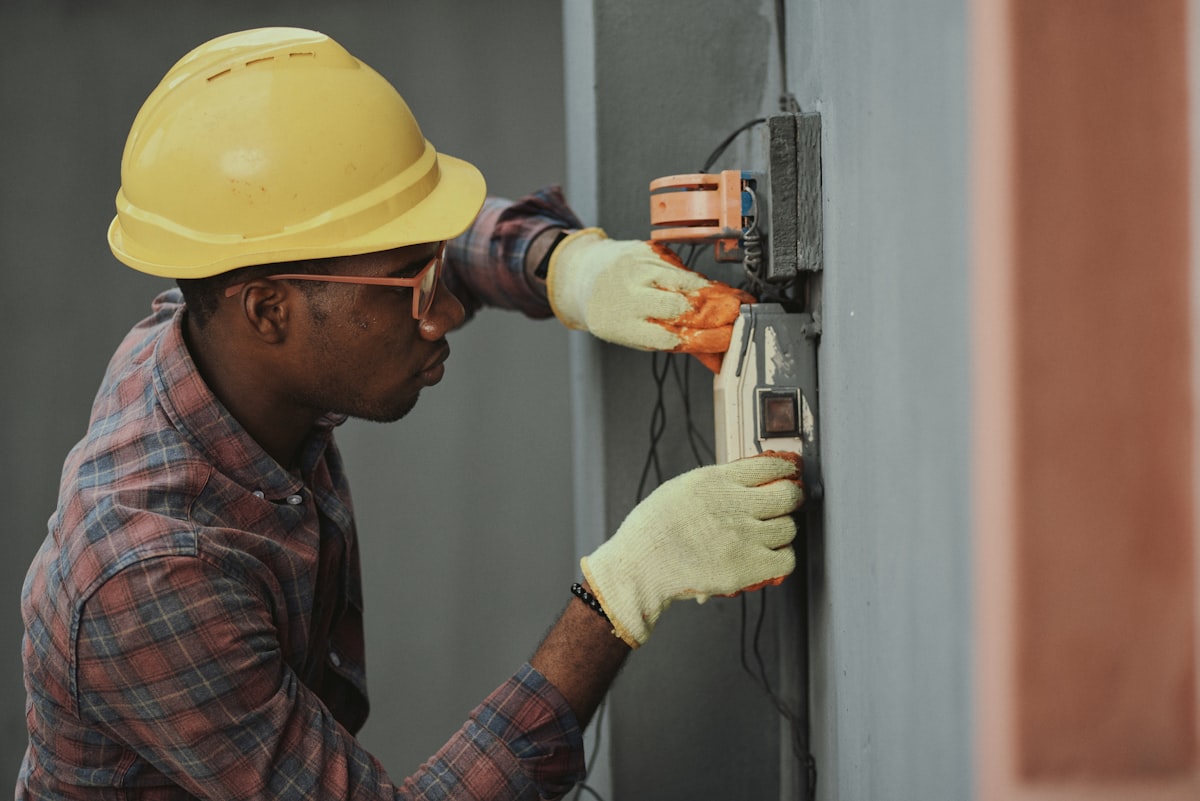 An electrician carefully testing a socket